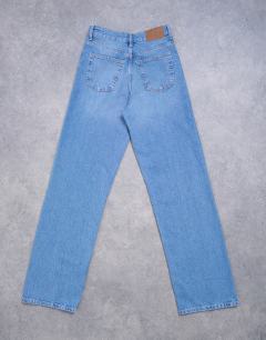 Model wearing Tall mid rise loose fit straight jean in vintage blue