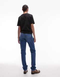 Model wearing Tall Mom high rise jean in mid blue