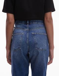 Model wearing Tall Mom high rise jean in mid blue