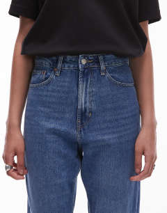 Model wearing Tall Mom high rise jean in mid blue