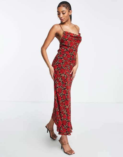 Black dress with allover red rose floral nprint. Rose design
Cowl neck with spaghetti straps with crossover tie back.