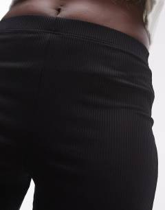 Model wearing Tall skinny rib flared trouser in black