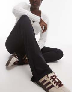 Model wearing Tall skinny rib flared trouser in black