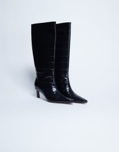Model wearing Tanya point toe knee high boot in black croc