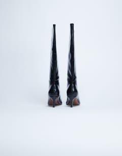 Model wearing Tanya point toe knee high boot in black croc