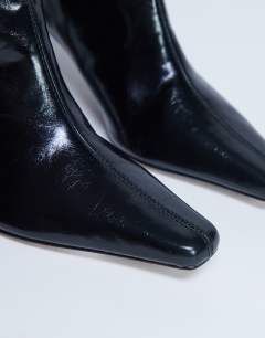 Model wearing Tanya point toe knee high boot in black