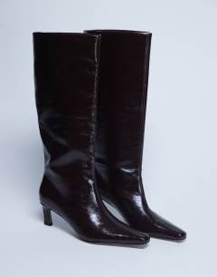 Model wearing Tanya point toe knee high boot in dark chocolate