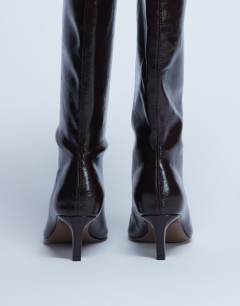 Model wearing Tanya point toe knee high boot in dark chocolate