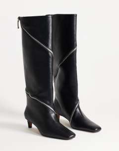 Model wearing Tao zip detail knee high boot in black
