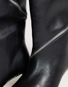 Model wearing Tao zip detail knee high boot in black