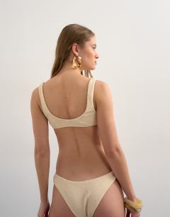 Model wearing Tara crinkle high leg cheeky bikini bottom in off white