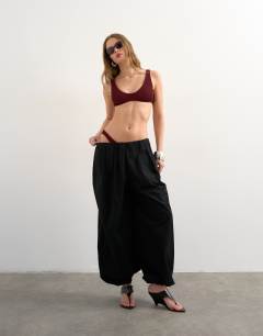 Model wearing Tara crinkle scoop bikini top in aubergine