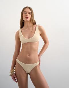 Model wearing Tara crinkle thong bikini bottom in off white