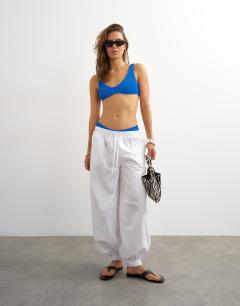 Model wearing Tara scoop bikini top in blue