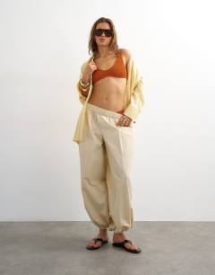 Model wearing Tara scoop bikini top in rust