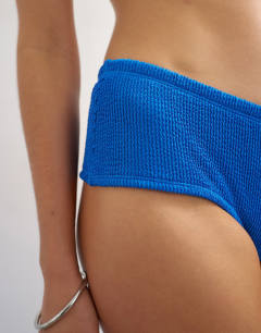 Model wearing Tara short cheeky bikini bottom in blue