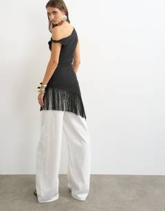 Model wearing Tassel hem asymmetric top in black