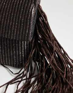 Model wearing Tassel oversized weave clutch bag in chocolate
