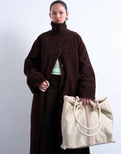 Model wearing Tate shearling tote bag in off white