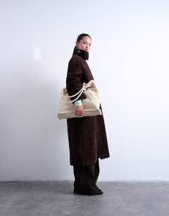 Model wearing Tate shearling tote bag in off white