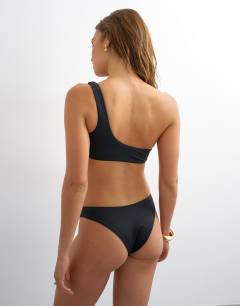 Model wearing Tatum one shoulder bikini top in black