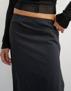 Model wearing Techy 90s length skirt in black