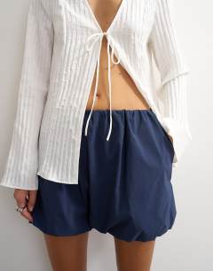 Model wearing Techy bubble hem shorts in navy