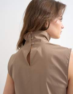 Model wearing Techy funnel drawstring hem top in mocha