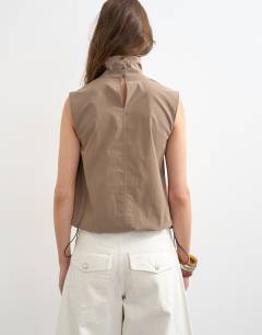 Model wearing Techy funnel drawstring hem top in mocha