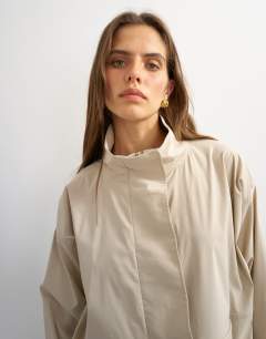Model wearing Techy funnel neck jersey track top in stone