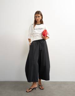 Model wearing Techy oversized ovoid mid length trouser in black