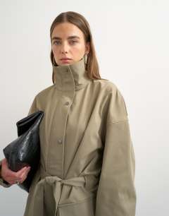 Model wearing Techy tie waist funnel neck jacket in neutral