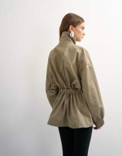 Model wearing Techy tie waist funnel neck jacket in neutral