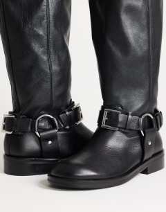 Model wearing Tee premium leather knee high riding boot in black