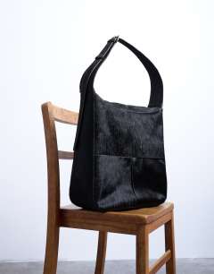 Model wearing Teegan hair on real leather oversize weave tote in chocolate