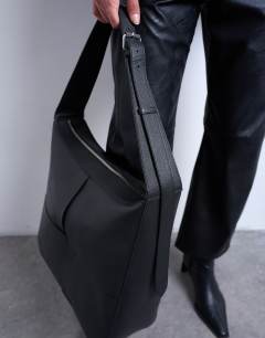 Model wearing Teegan premium real leather oversize weave tote in black