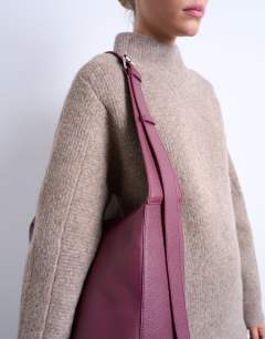 Model wearing Teegan premium real leather oversize weave tote in burgundy