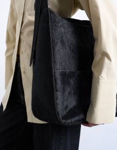 Model wearing Teegan real pony leather oversize weave tote in chocolate