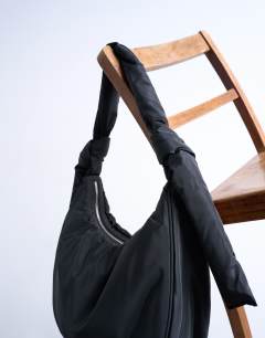 Model wearing Terry nylon shoulder zip pocket bag in black