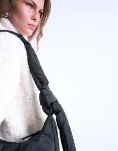 Model wearing Terry nylon shoulder zip pocket bag in black
