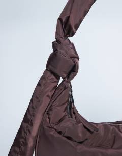 Model wearing Terry nylon shoulder zip pocket bag in chocolate