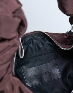 Model wearing Terry nylon shoulder zip pocket bag in chocolate