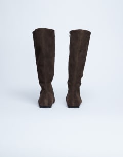 Model wearing Tess real suede knee high flat boot in chocolate