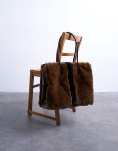 Model wearing Teven faux fur tote bag in brown