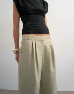 Model wearing Textured plain elasticated tailored trouser in stone