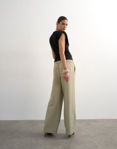 Model wearing Textured plain elasticated tailored trouser in stone