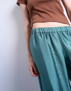 Model wearing Textured satin low rise straight leg drawcord trouser in turquoise