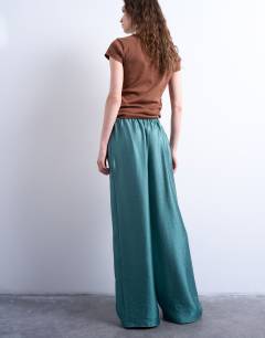 Model wearing Textured satin low rise straight leg drawcord trouser in turquoise
