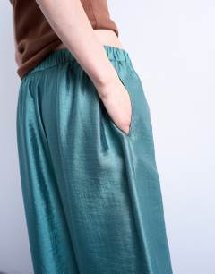 Model wearing Textured satin low rise straight leg drawcord trouser in turquoise