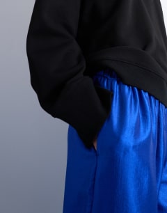 Model wearing Textured satin straight leg drawcord trouser in mid blue